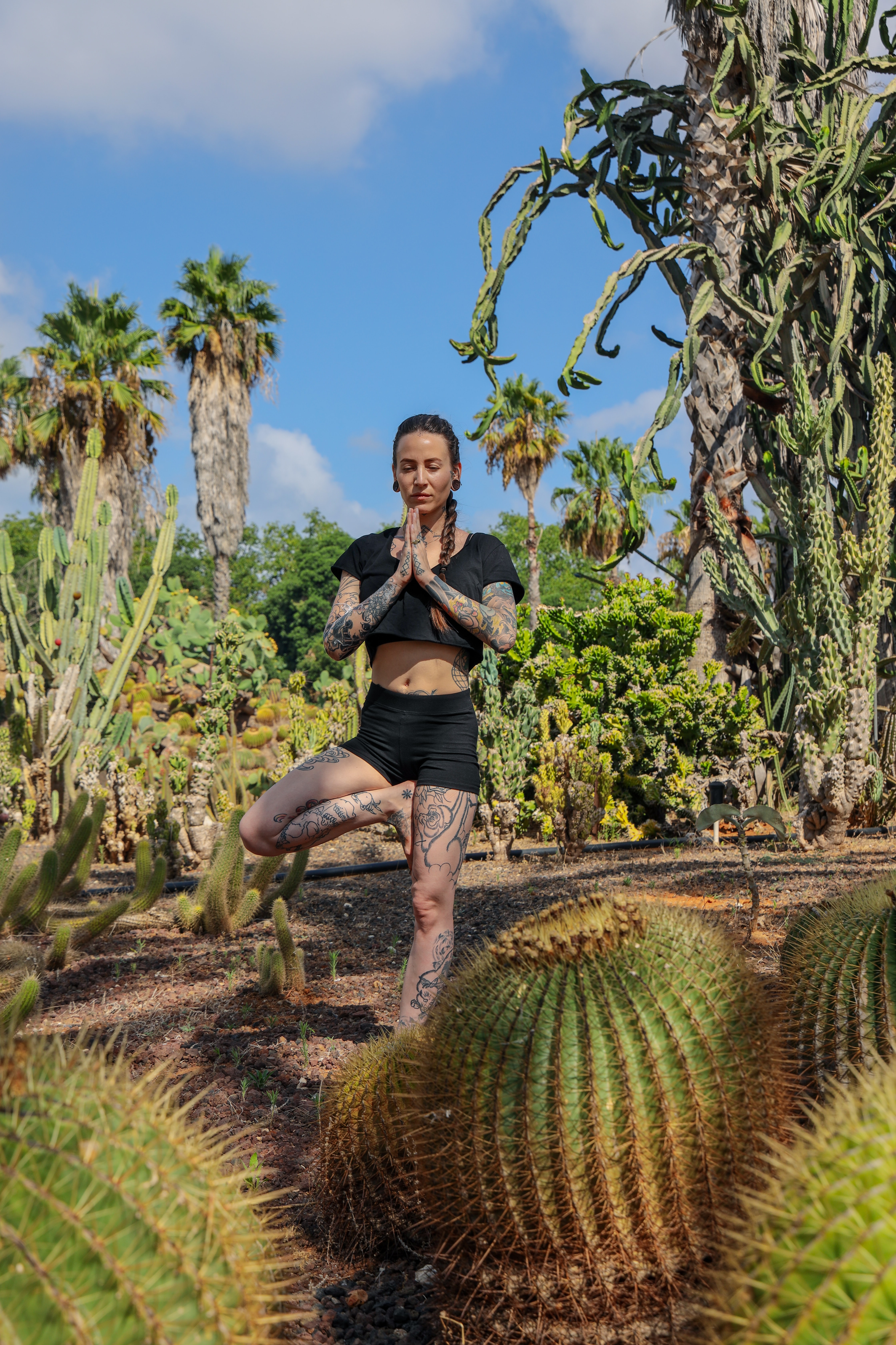 Women in an outdoor space doing yoga.